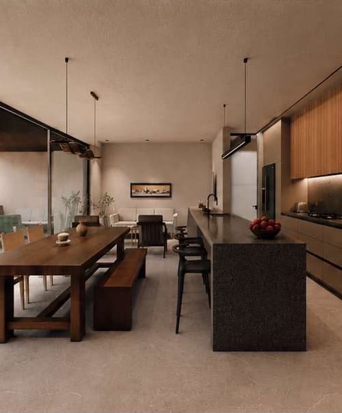 Casa Siena kitchen with warm wood finishes and a dark granite peninsula